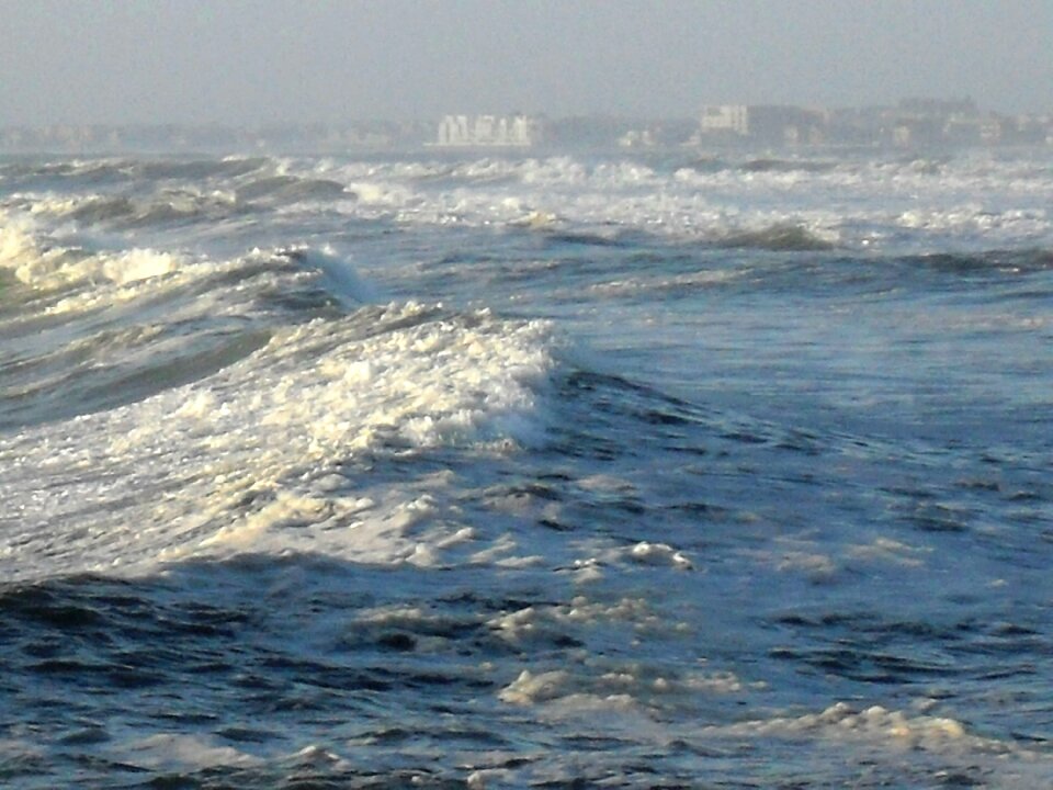 Sky buildings on horizon light on water