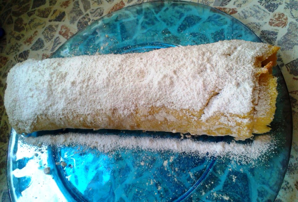Sponge cake roulade golden brown white powdered sugar