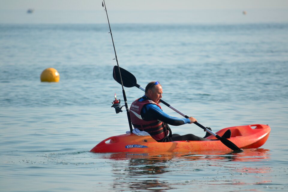 Paddling fisherman sea