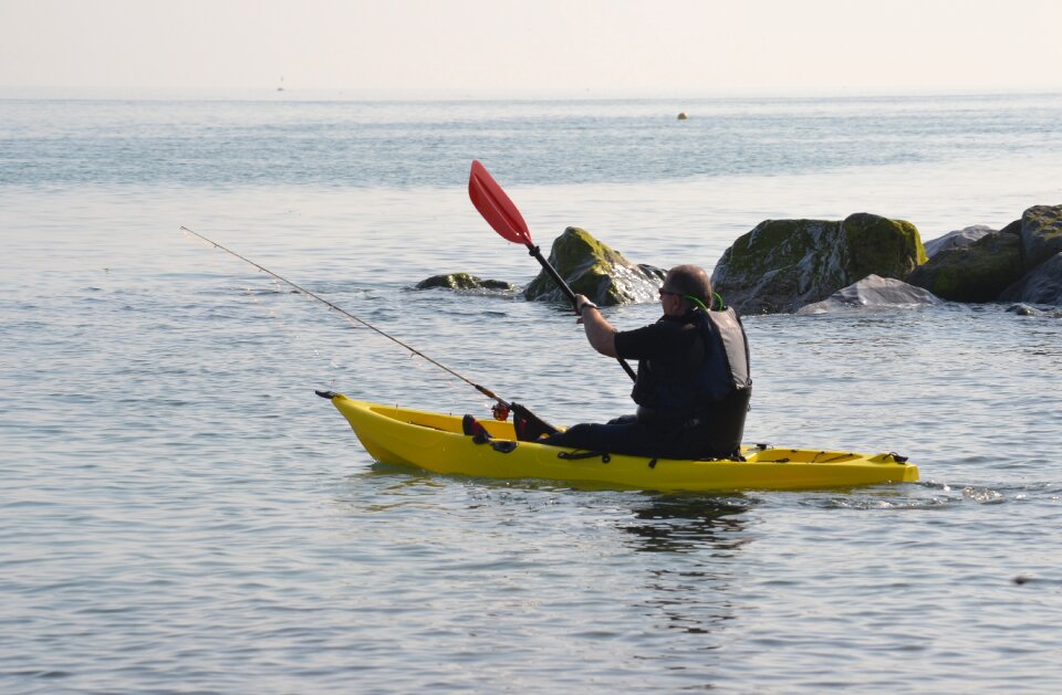 Paddling fisherman sea