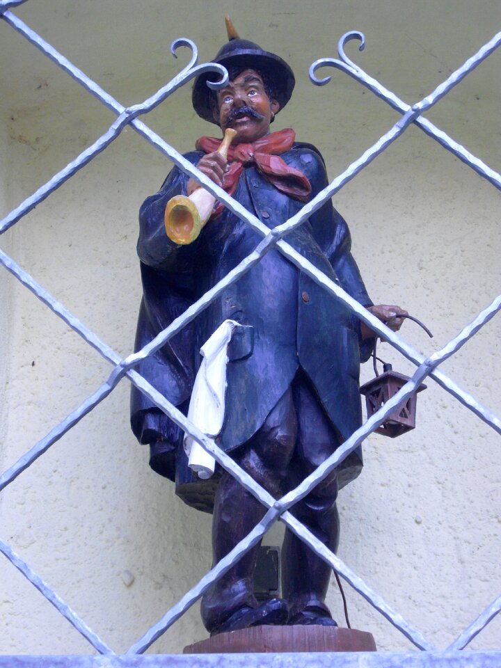 Stone figure niche behind bars