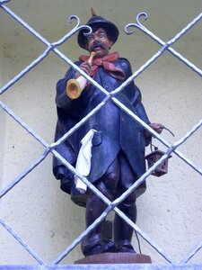 Stone figure niche behind bars photo