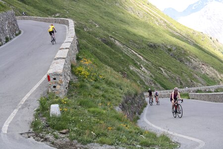 Sport racing cyclists pass road photo