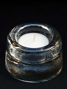Burning down candlestick glass photo