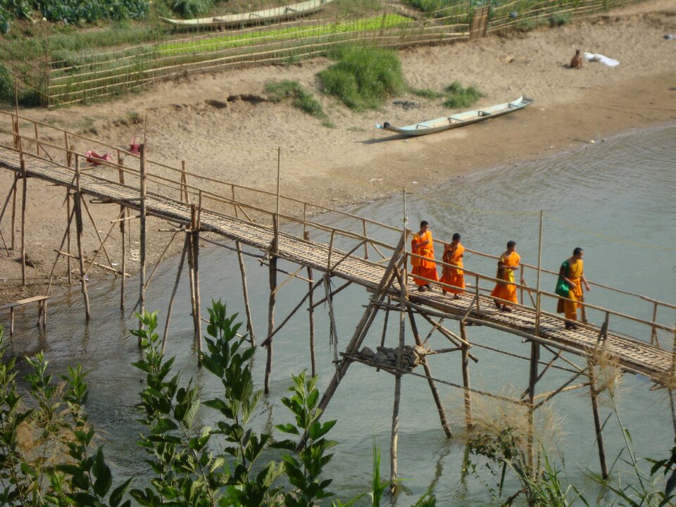 Monks crossing bridge laos