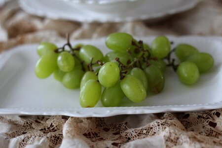 Close-up green fruit white china
