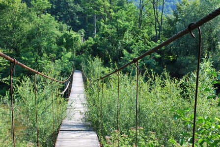 Small river suspension bridge trail photo