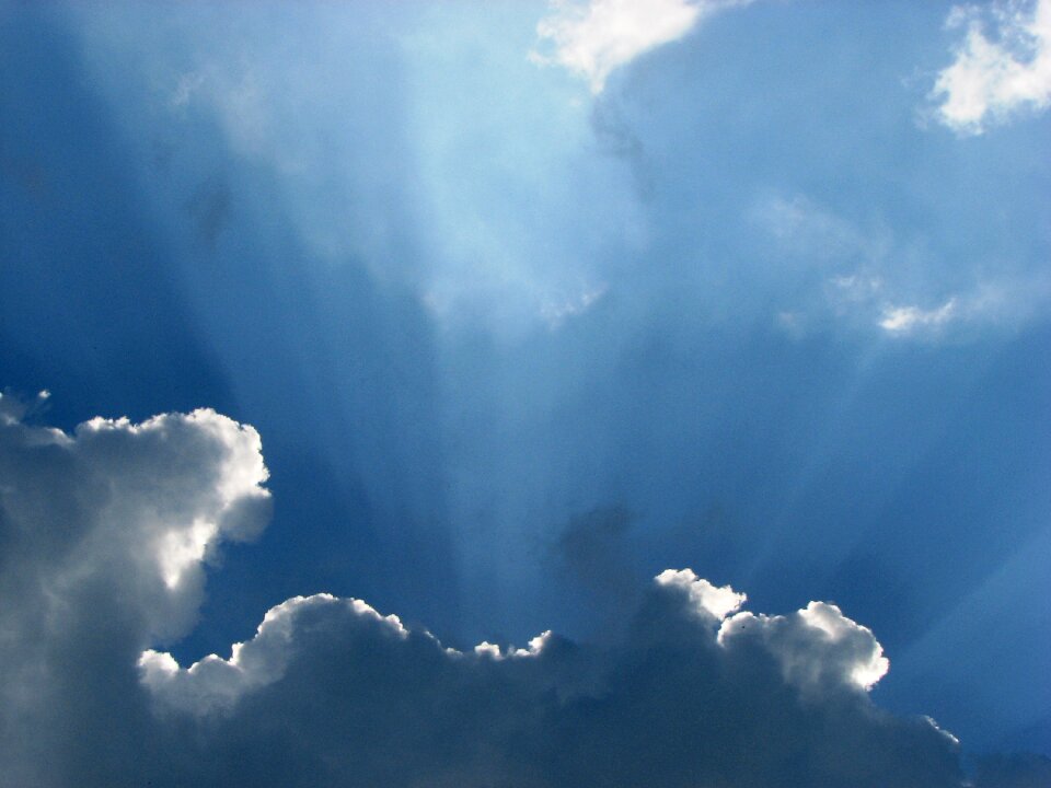 Clouds form sunbeam white photo