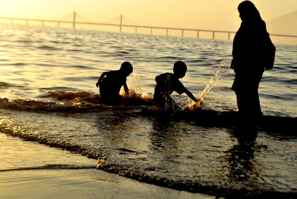 Mother splashing around sea