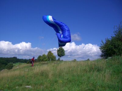 Paraglider floating sailing sky