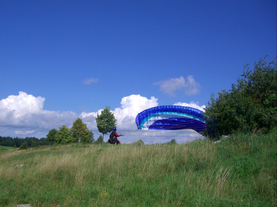 Paraglider floating sailing sky