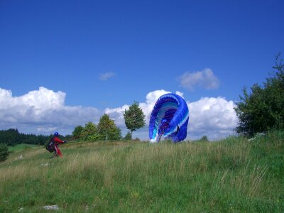 Paraglider floating sailing sky
