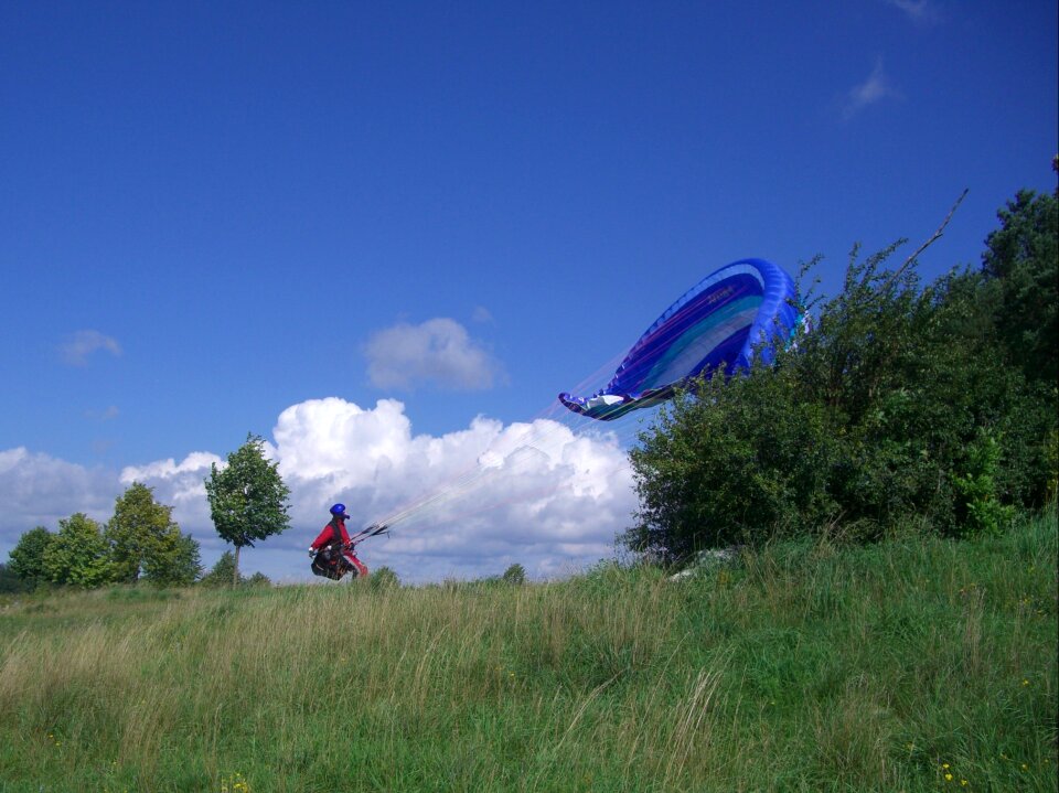 Paraglider floating sailing sky