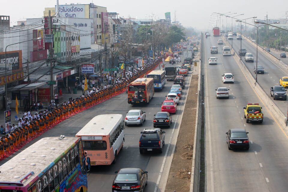 Monks walking cars