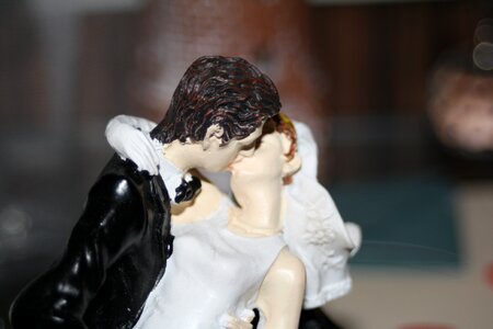 Bride and groom kiss figure photo