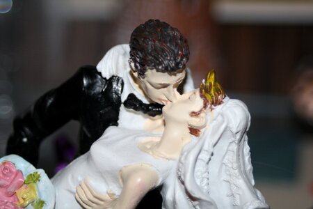 Bride and groom kiss figure photo