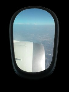 Flying plane black window photo