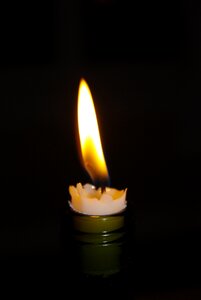 Candlelight burning black bottle photo