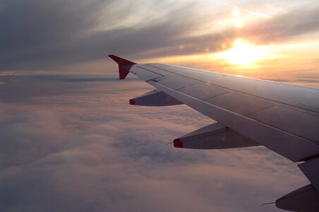Clouds flying aircraft wing photo
