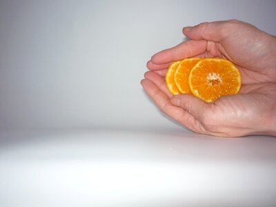 Hand hold mandarin slices