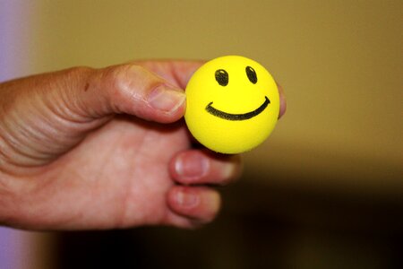Laughing face yellow hand
