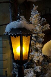 Artificial snow lighting street lamp photo