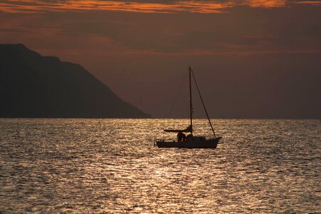 Sunset sea sailing boat photo