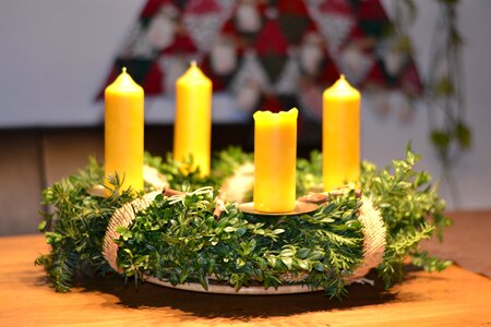 Beeswax candles green branches photo