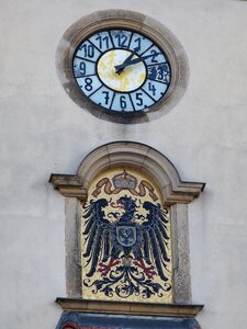 Clock face transience coat of arms
