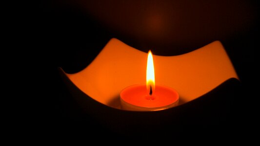 Burning candle dark light photo