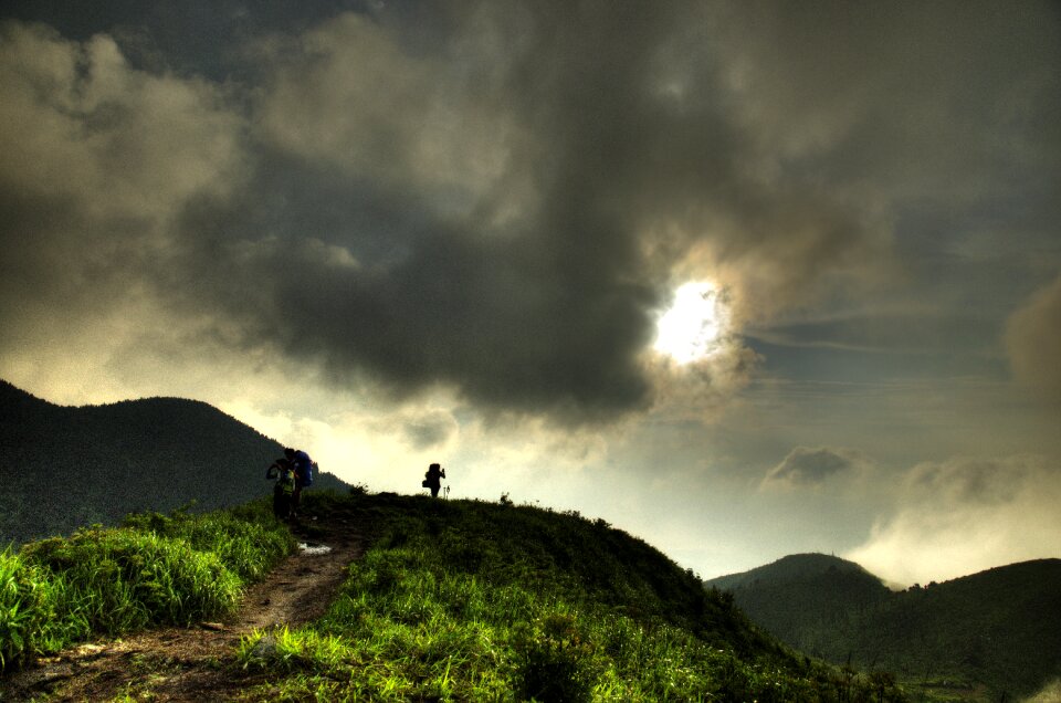 Backpackers sunset dark clouds