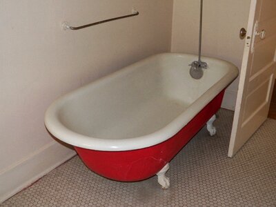 Antique claw tub brown bathroom
