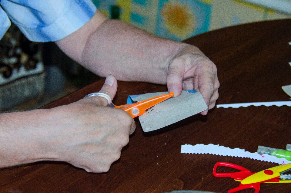 Hands scissors cut paper