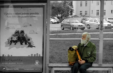 Old man bus stop black and white photo