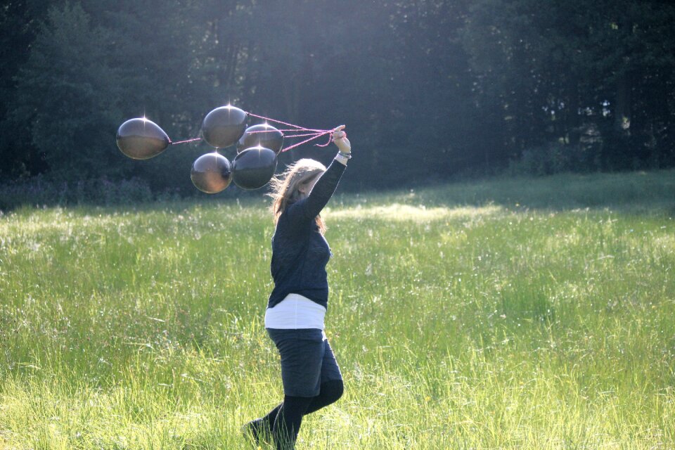 Girl balloons person