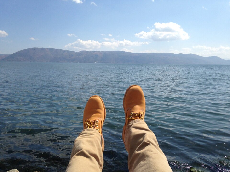 Blue sky feet yellow boots photo