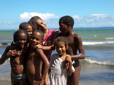Children laughing beach ethnic