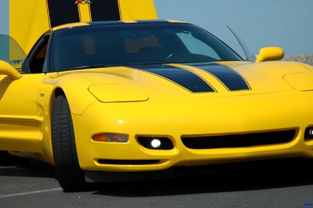 Yellow corvette ocean beach photo