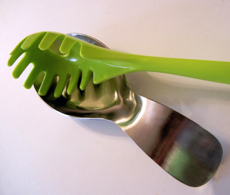 Green plastic utensil spaghetti spoon