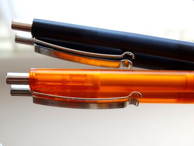 Writing utensil orange black photo