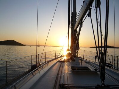 Sailing boat sunset sea photo