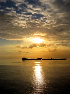 Manila bay sun clouds photo
