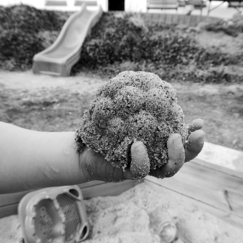 Sand cake child's hand play photo