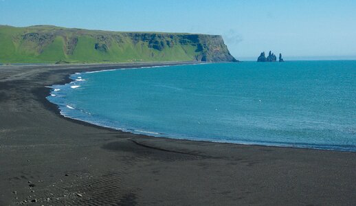 Beach black sand cliffs photo