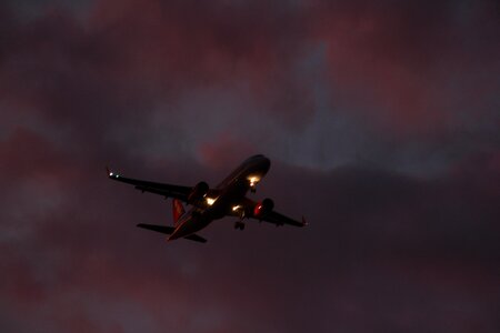Plane in the sky sunset twilight photo