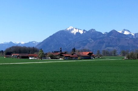 Overseas at the chiemsee blue sky green meadows photo
