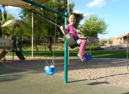 Girl swinging park photo