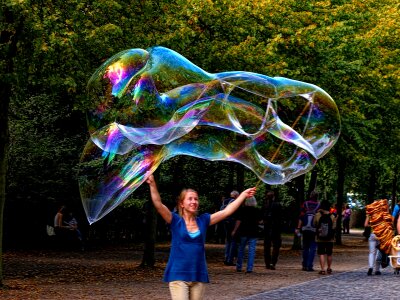 Giant bubble woman making soap bubbles seifenblasen berlin photo