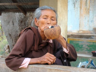 Burma old woman smoking photo