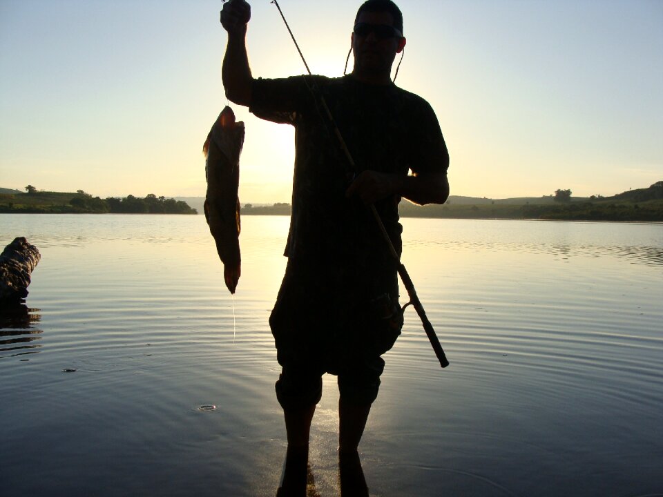Fisherman silhouette fish